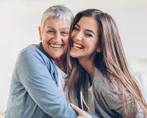 smiling women after dental implants in Santa Ana